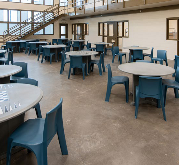 Custodial association area fitted with moulded tables and seating