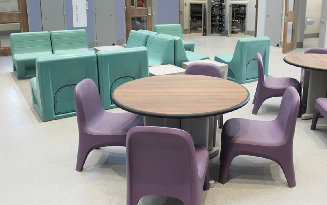 Custodial dayroom fitted with anti-ligature booth seating and tables